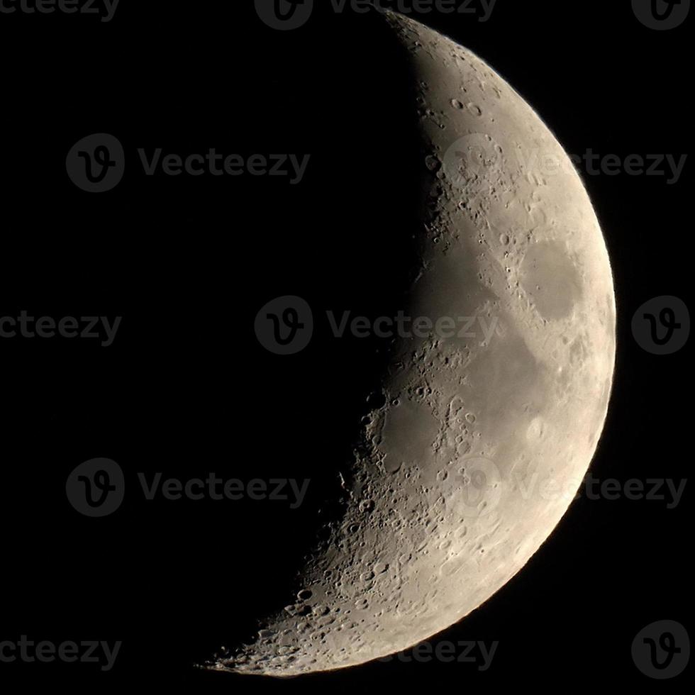 Waxing crescent moon seen with telescope photo