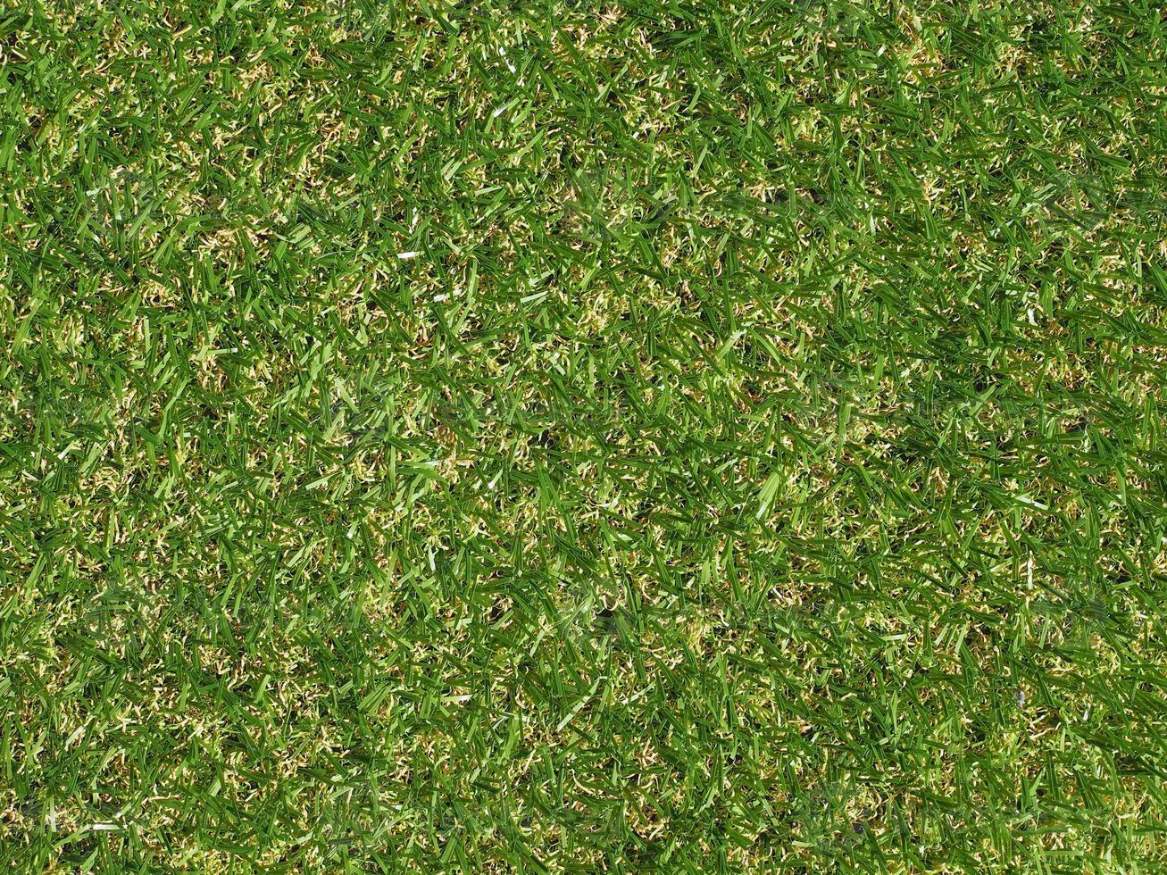 Green artificial synthetic grass meadow background photo