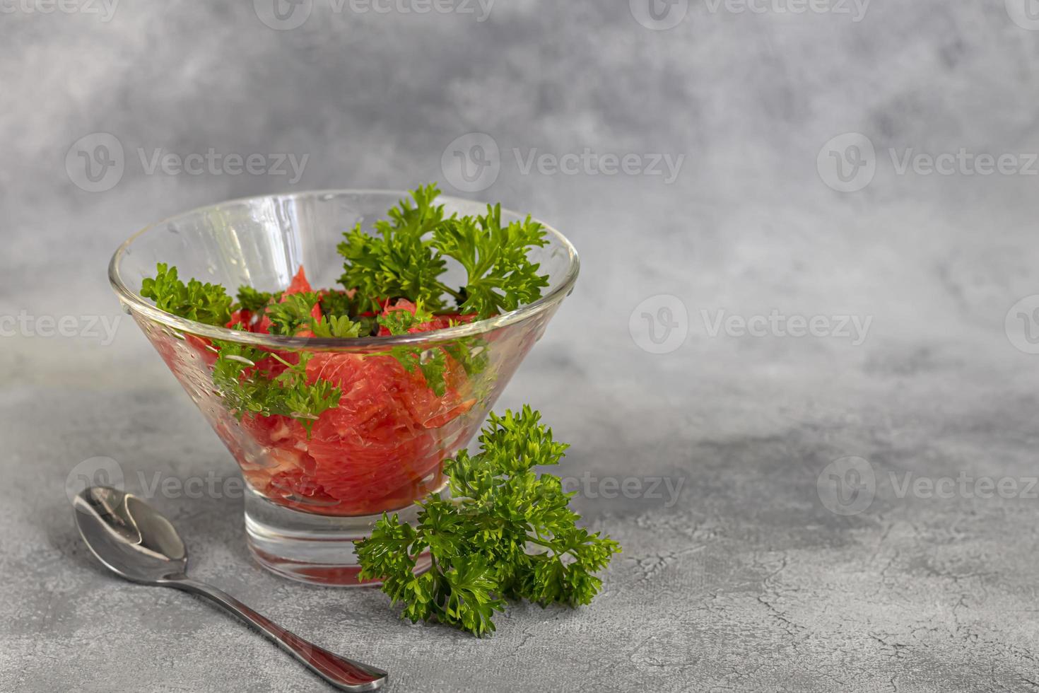 Summer salad with grapefruit on a light background with herbs. photo