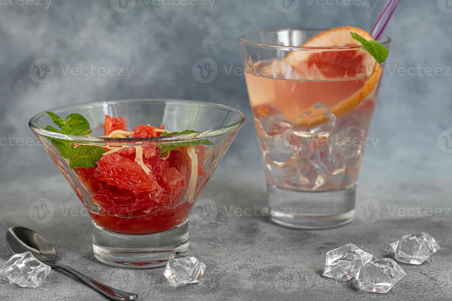 Summer salad with grapefruit on a light background with herbs. photo