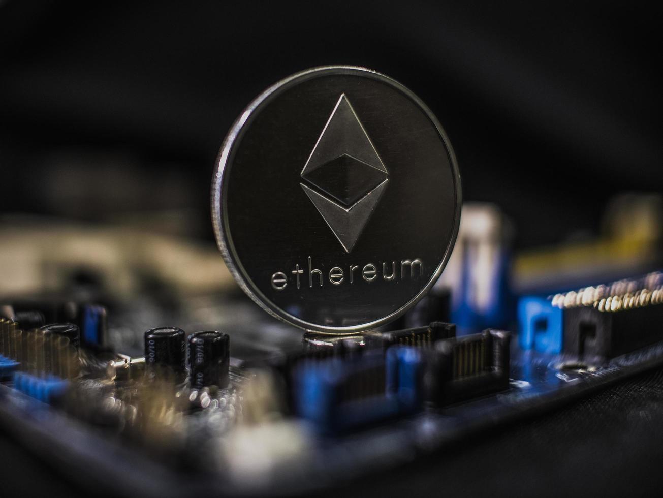 Coin ethereum on the background of a microcircuit photo