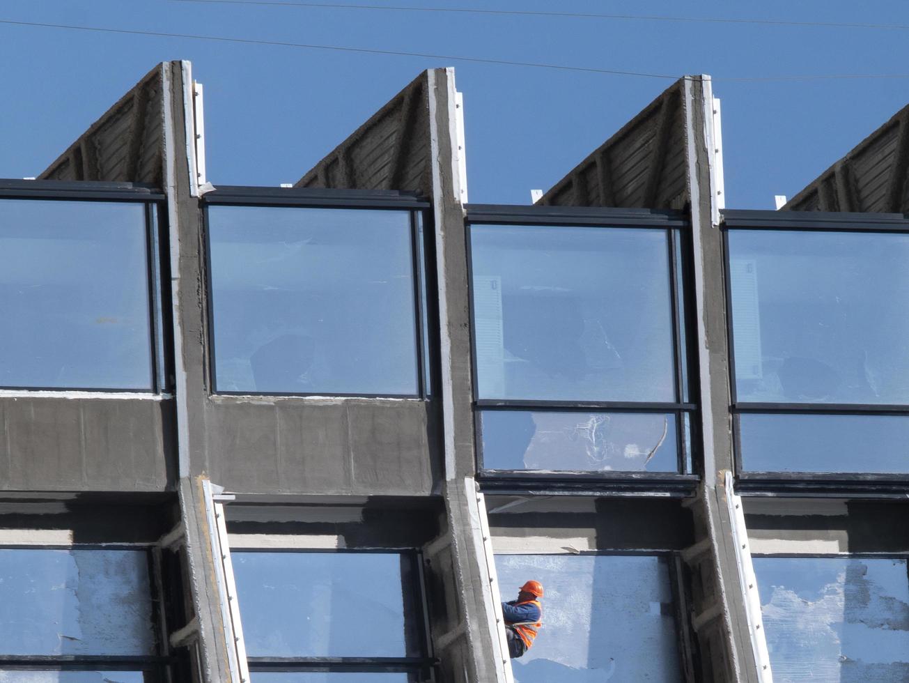 builder in helmet on the floor of a high-rise building photo