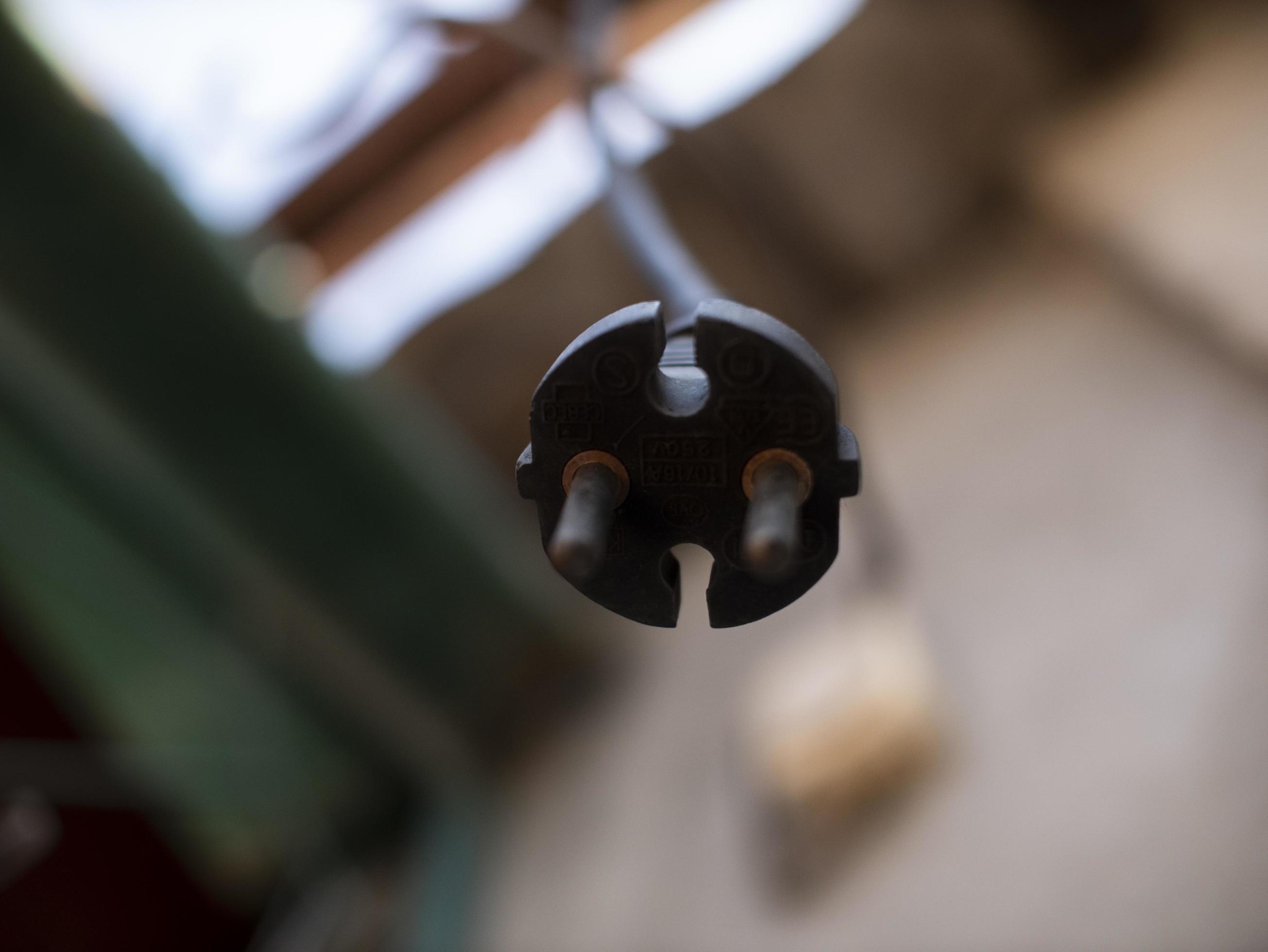 the plug from the socket hangs on the cord outdoor 3167283 Stock Photo