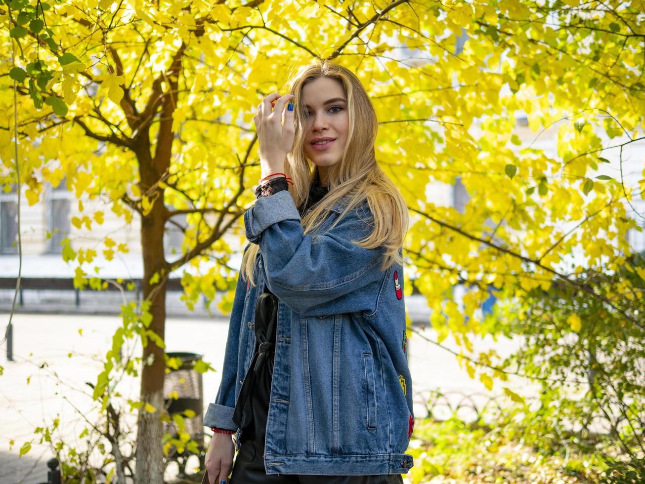 cute blonde girl standing on the street photo