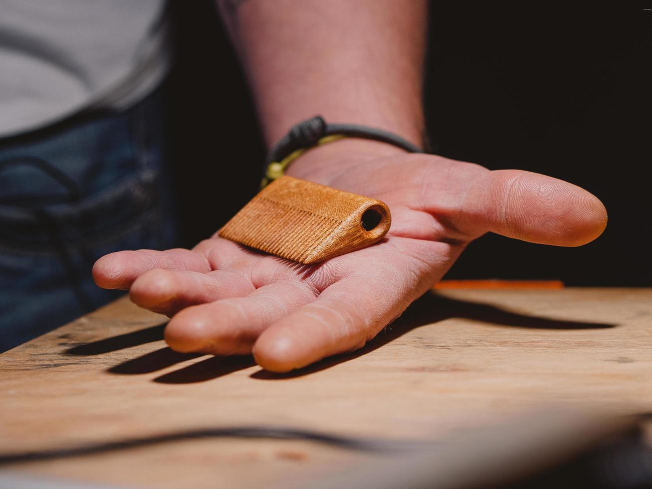 handmade beard comb in a man's hand. beard and mustache concept photo