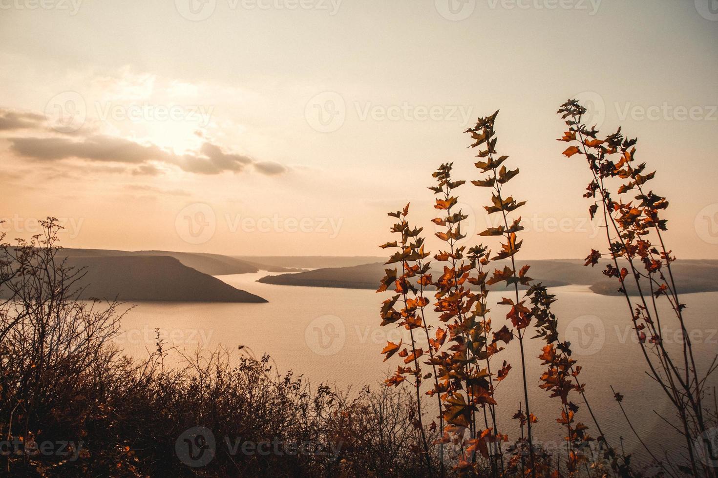Majestic sunset in the mountains landscape over a calm lake photo