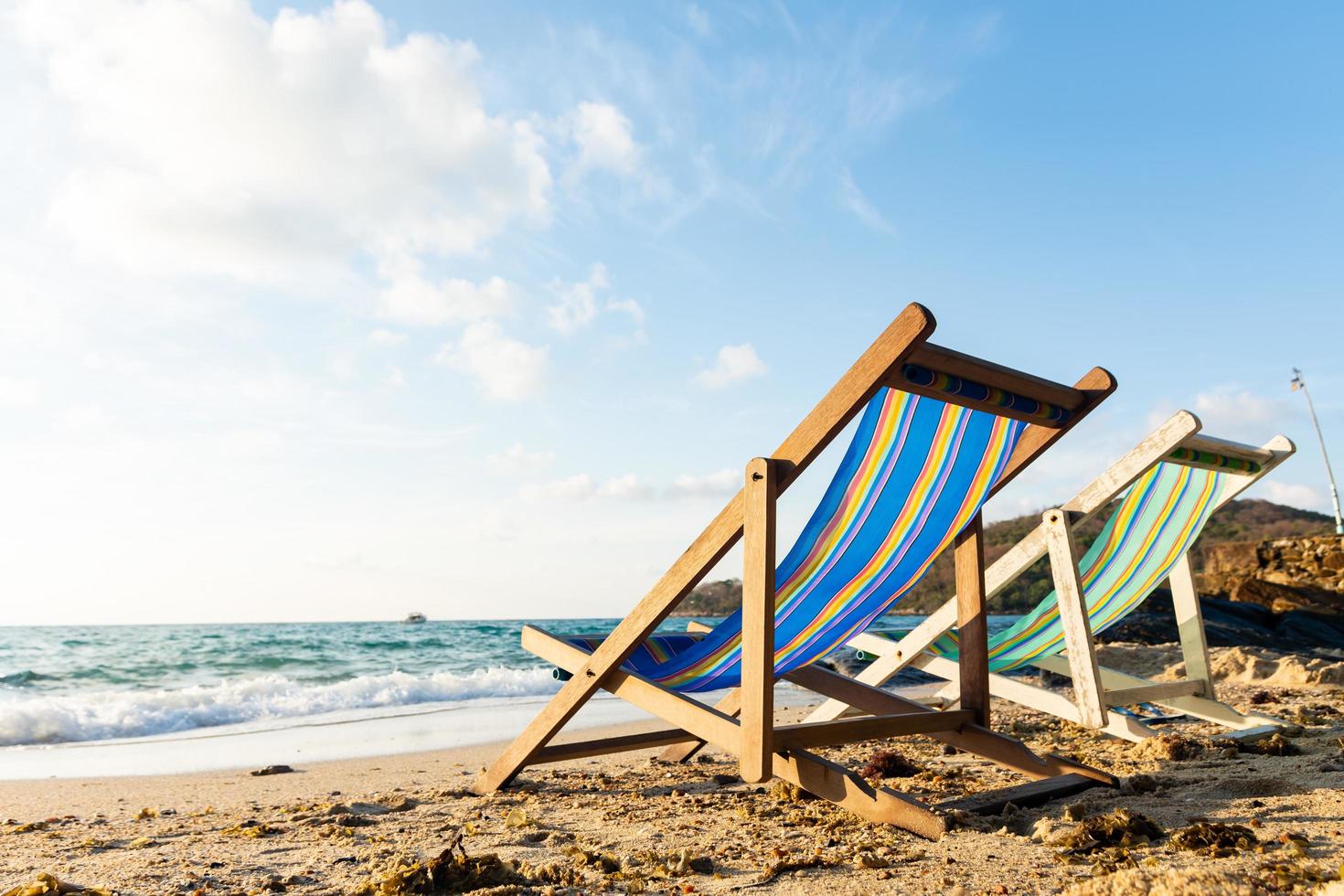 Summer vacation deckchairs on tropical beach photo