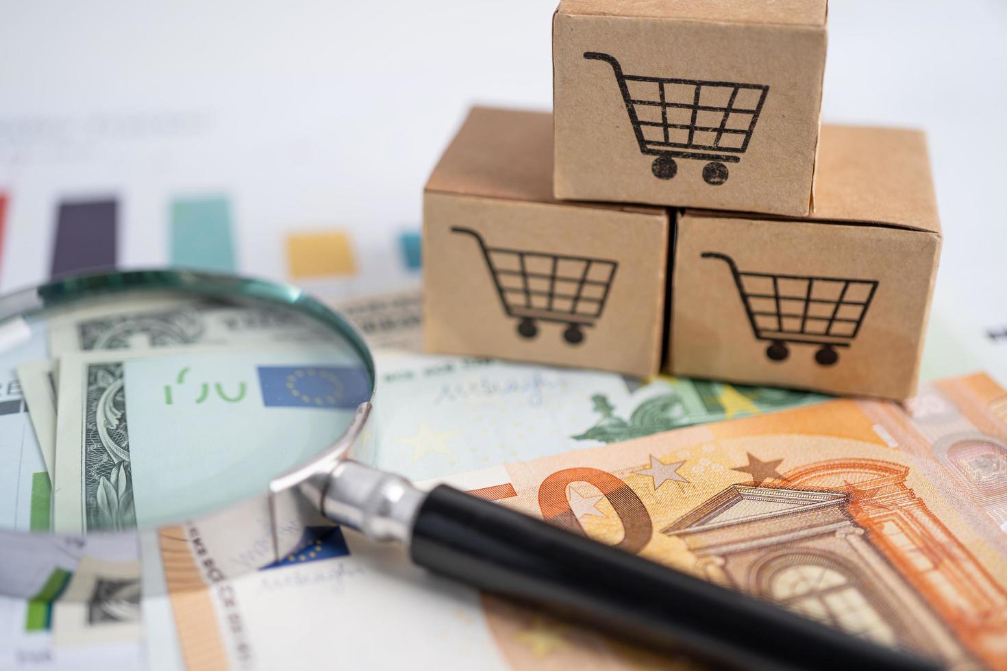 Shopping cart logo on box with magnifying glass and Euro banknotes. photo