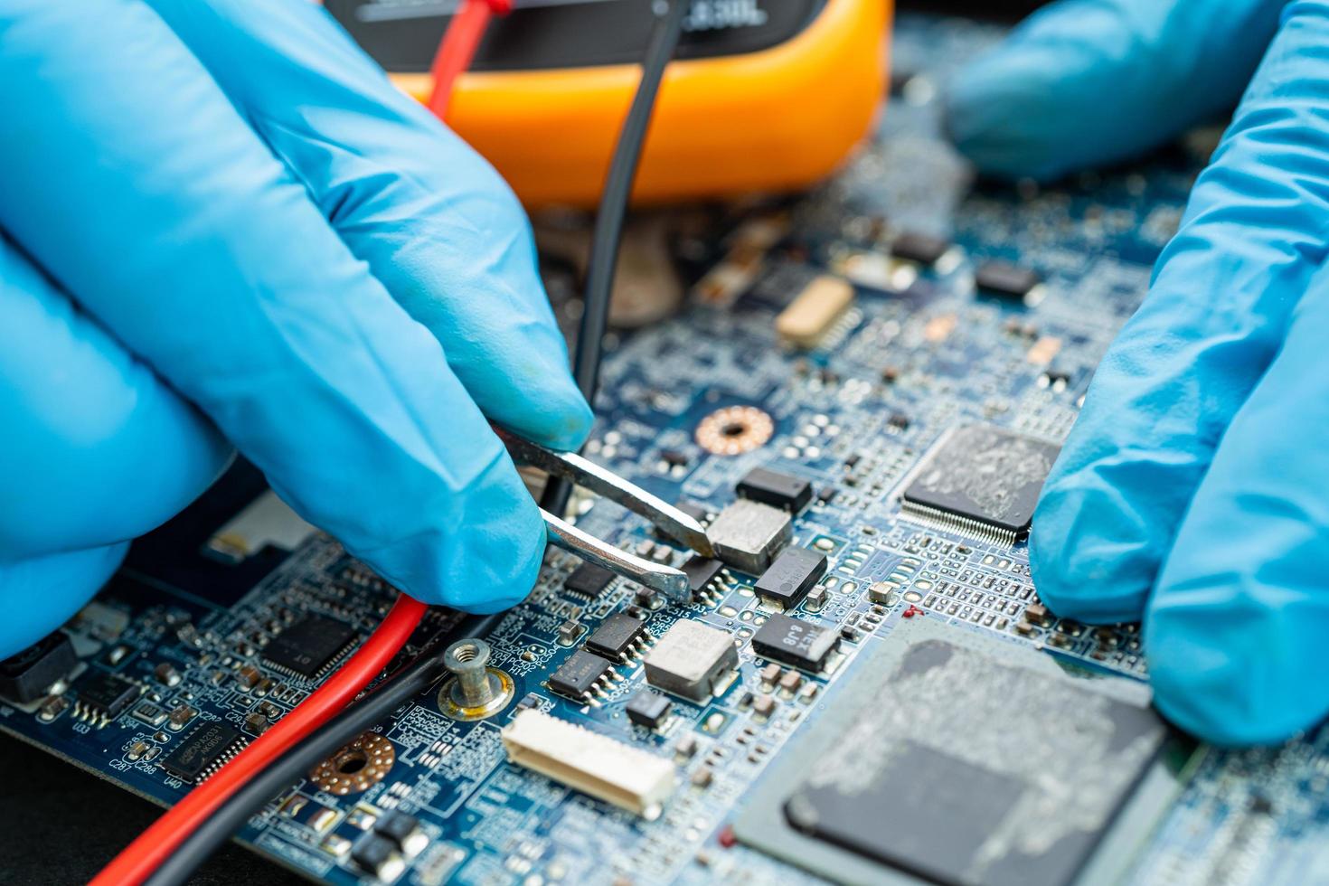 technician repairing inside of hard disk photo