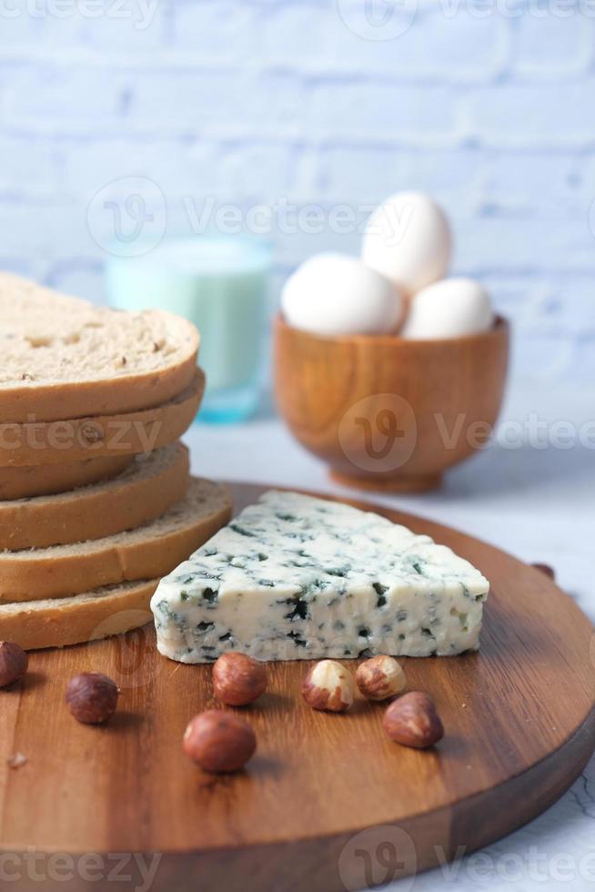 blue cheese , egg , milk and f brown bread on table photo