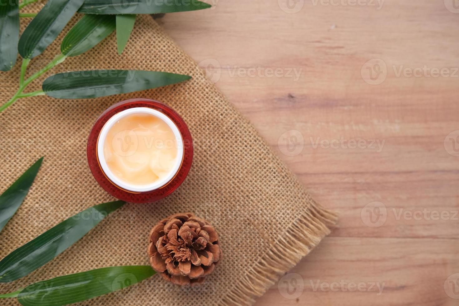 herbal cream cosmetic in a container on table, photo