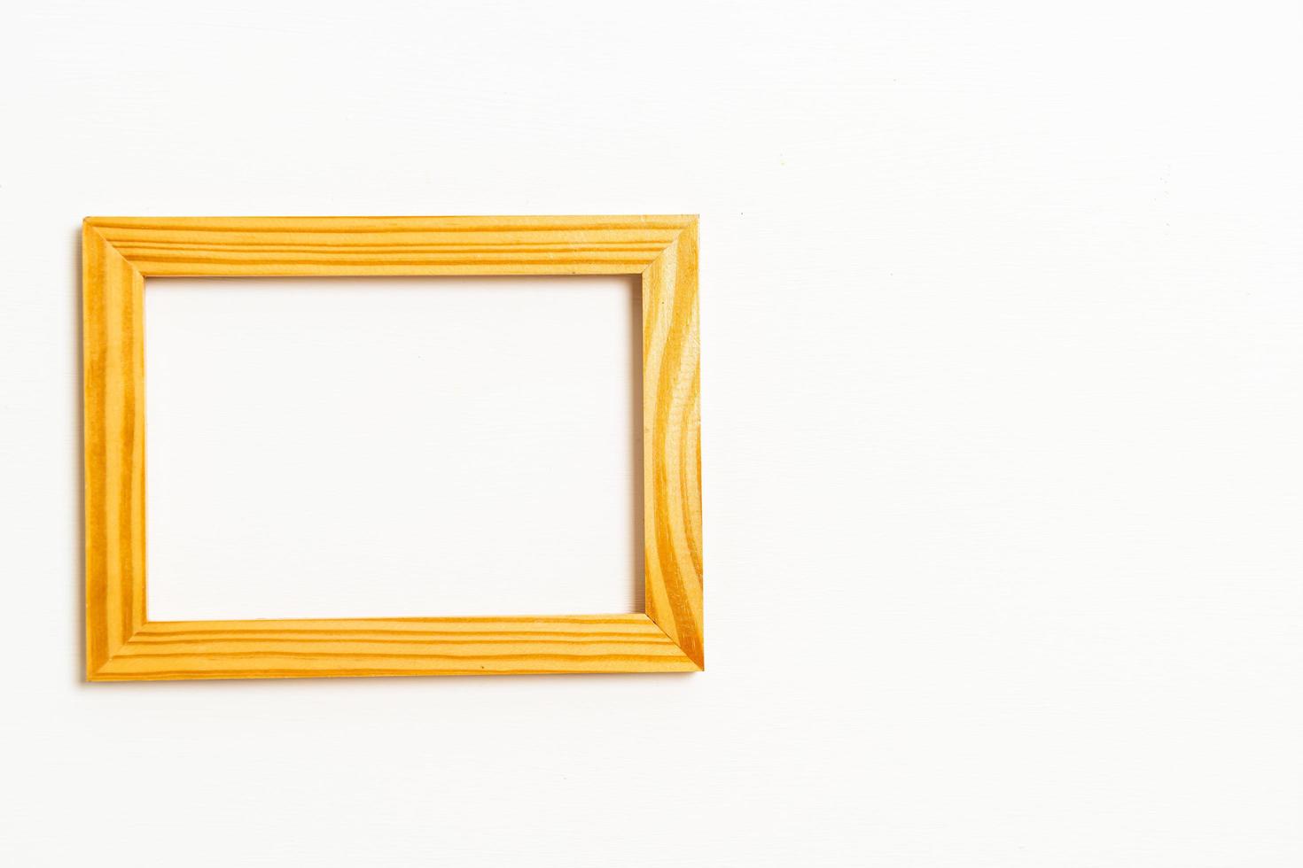 Empty picture frame on white wall background with copy space photo