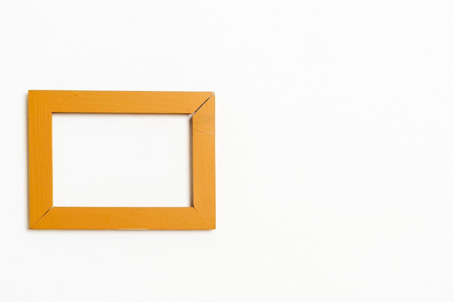 Empty picture frame on white wall background with copy space photo