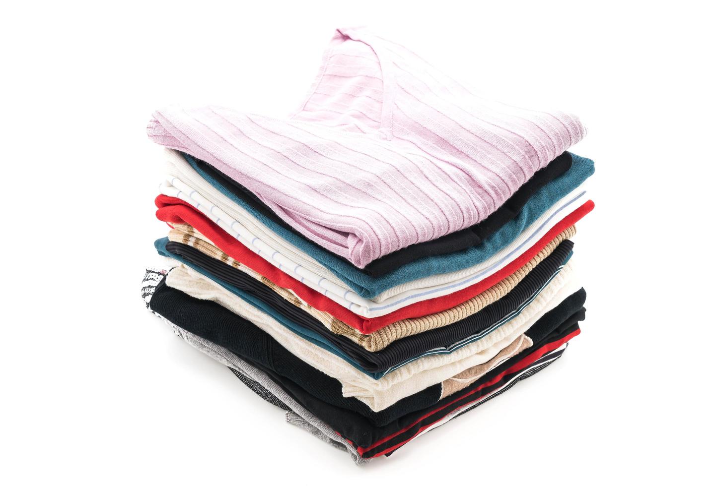 Stacks of clothing on white background photo