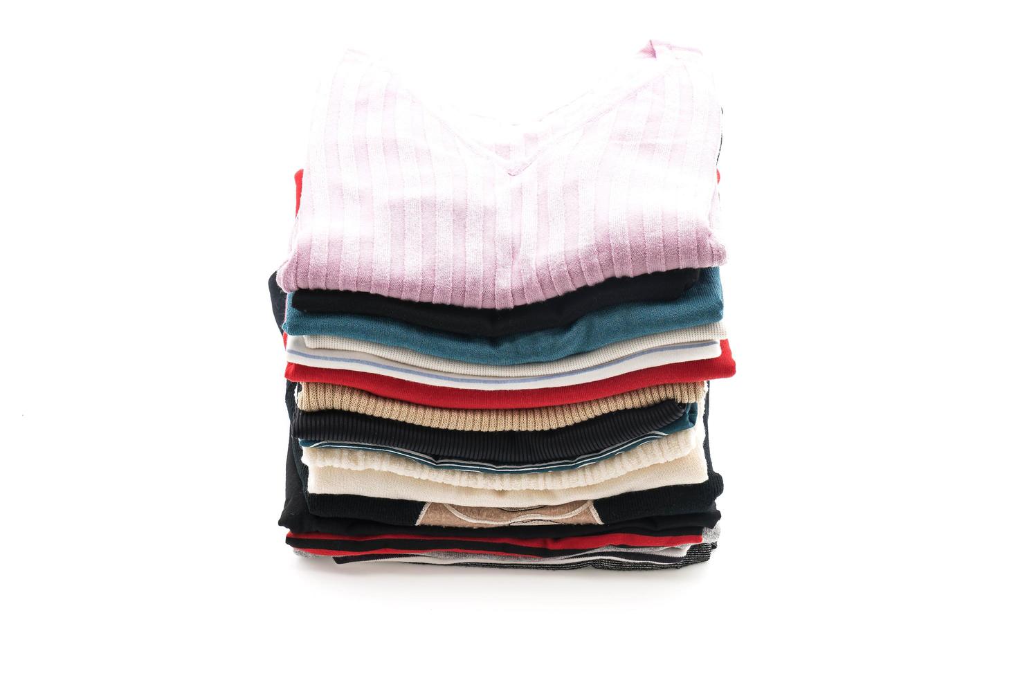 Stacks of clothing on white background photo