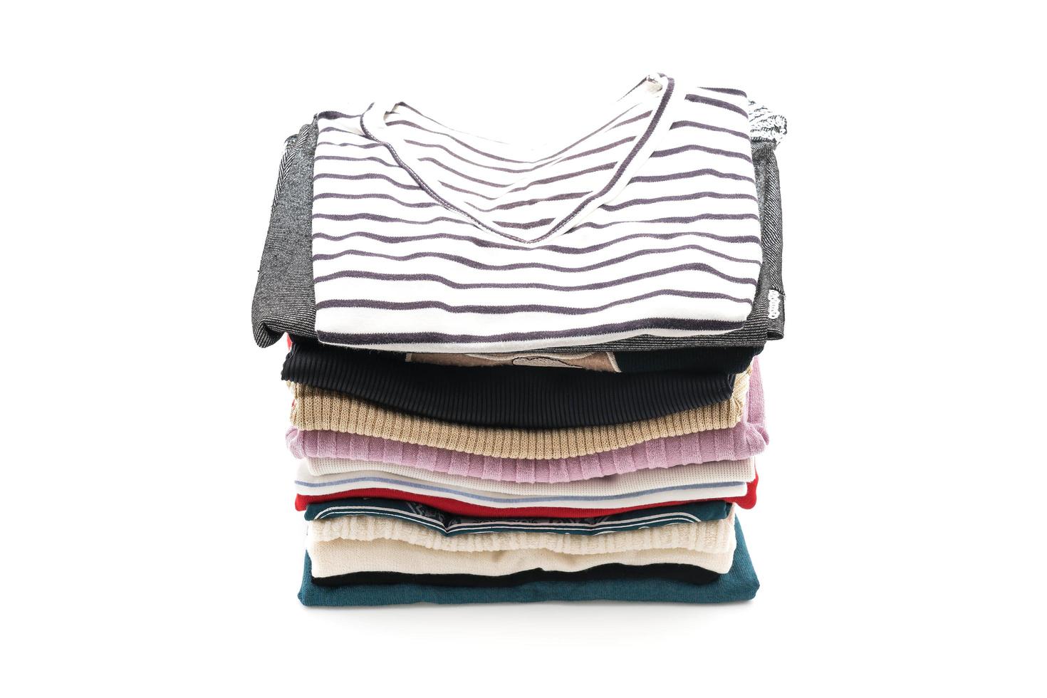 Stacks of clothing on white background photo