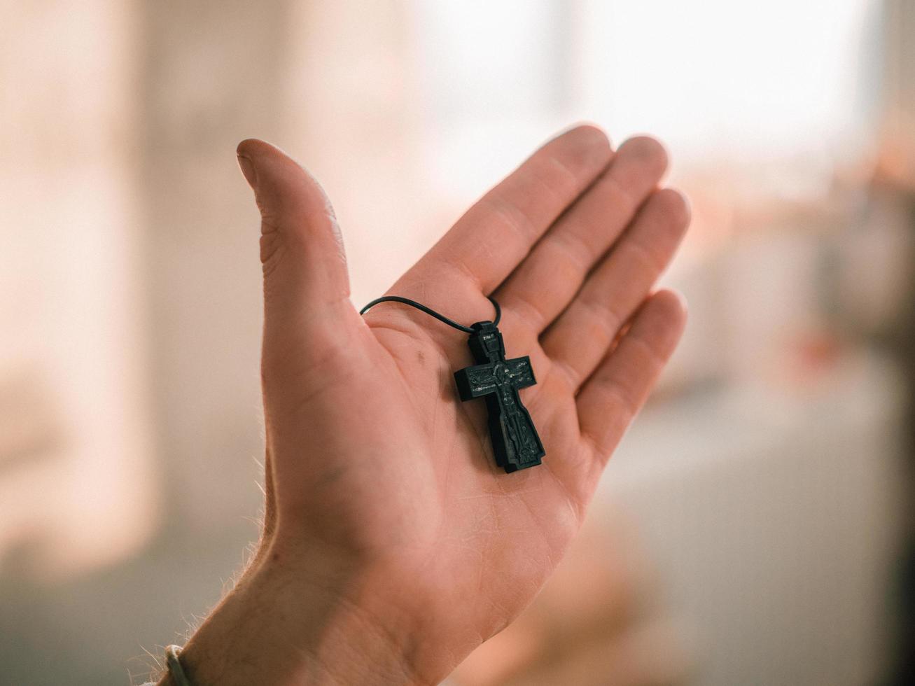 Wooden Orthodox cross in a man's palm photo