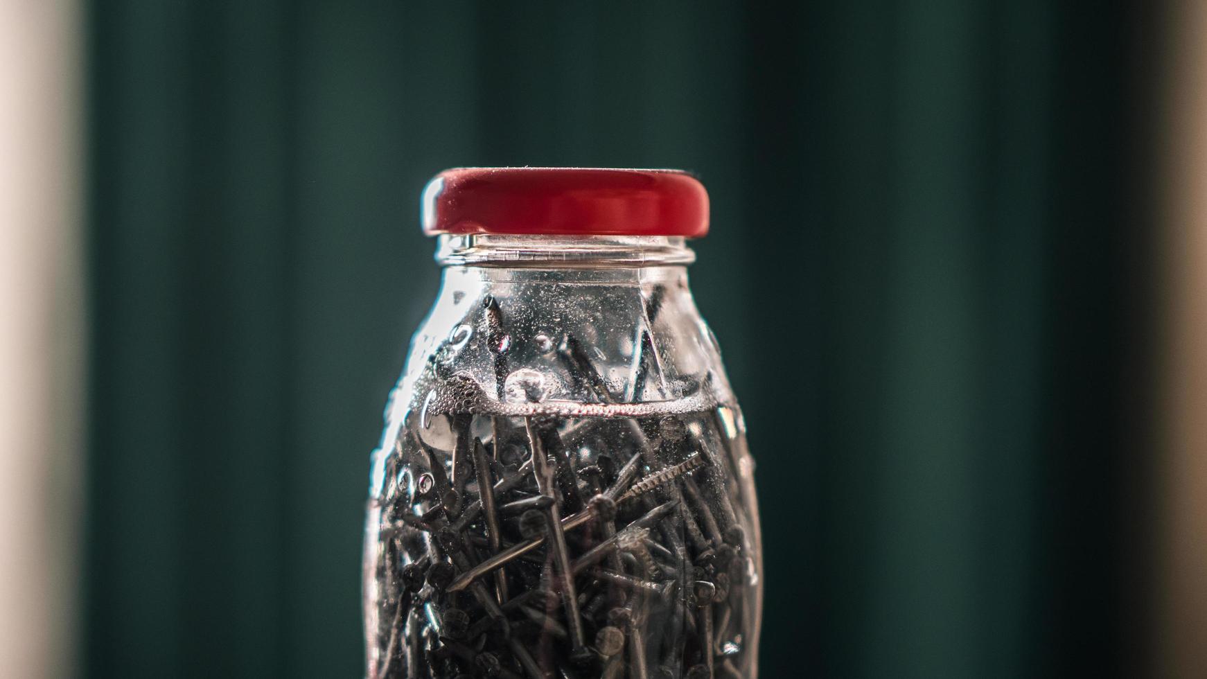 nails stain in a clear vinegar bottle. Making nail stain. wood stain photo