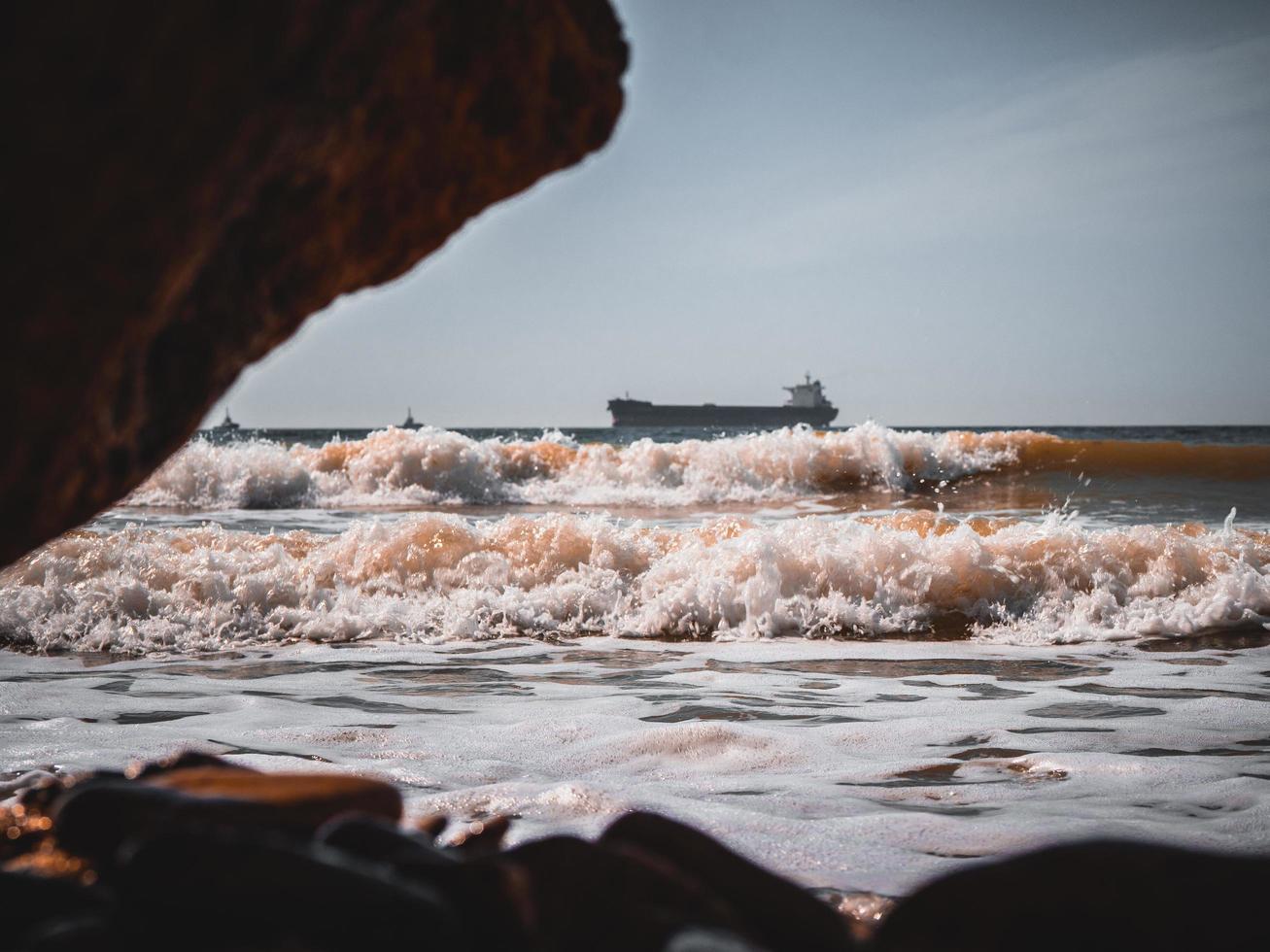 Sea waves on the shore of a large tanker ship. Wallpaper. High Quality photo