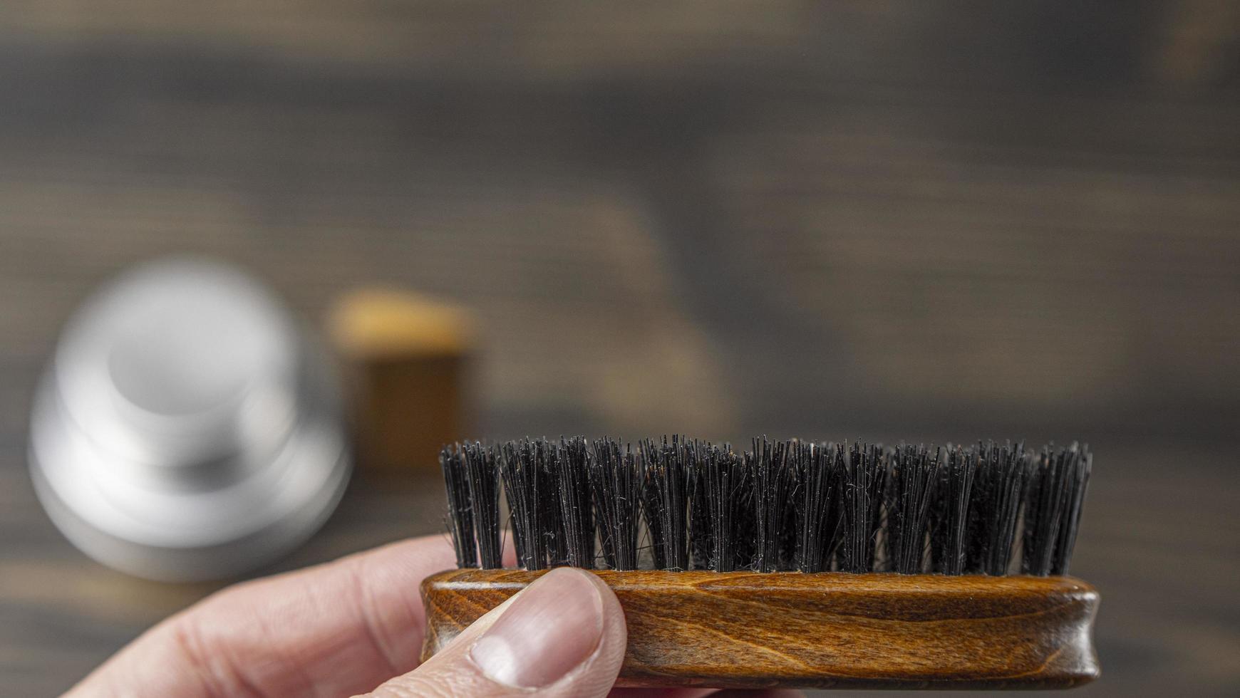 Beard Brush In A Male Hand On A Blurred Background photo