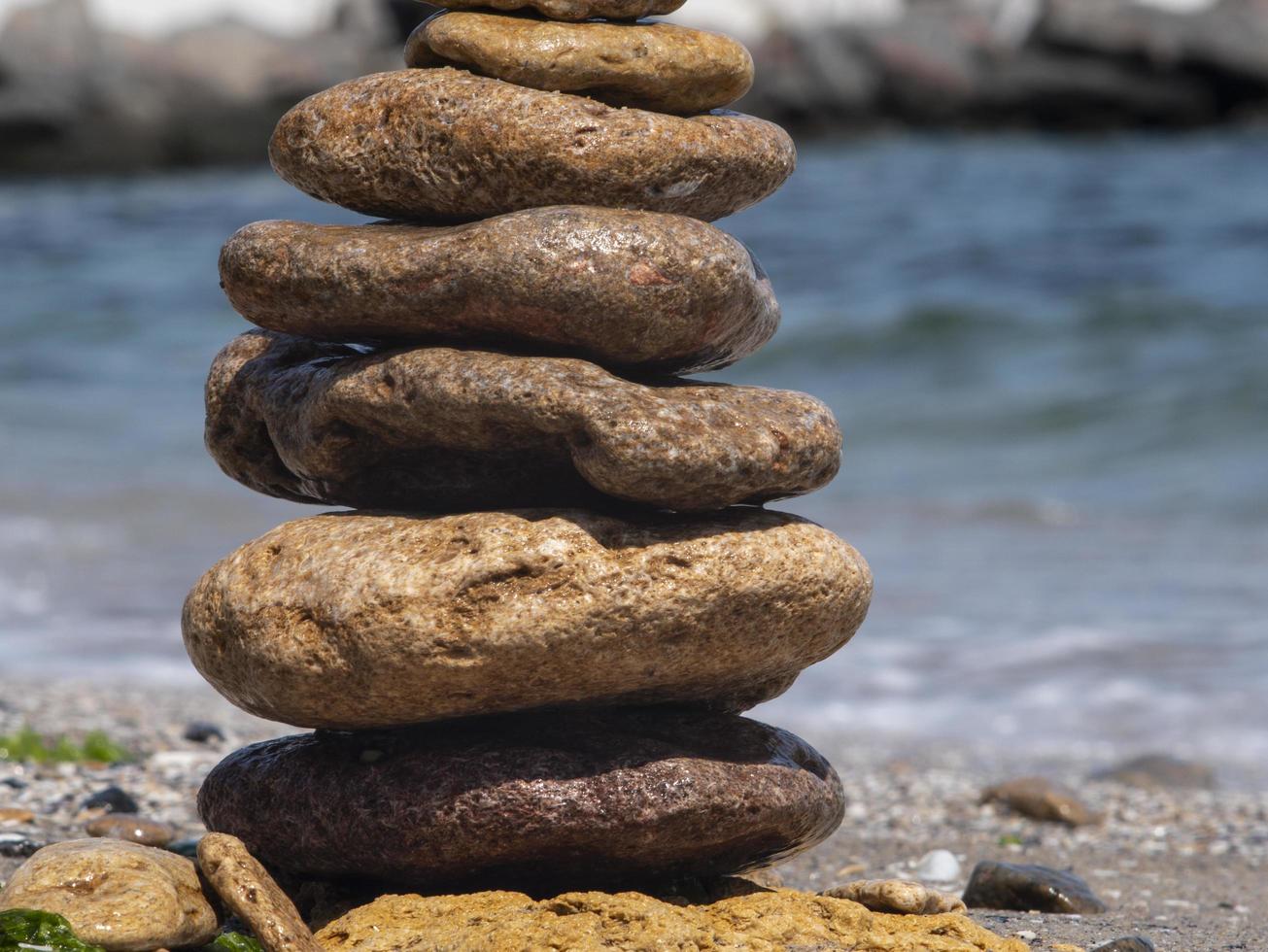 sea flat stones are standing one on another photo