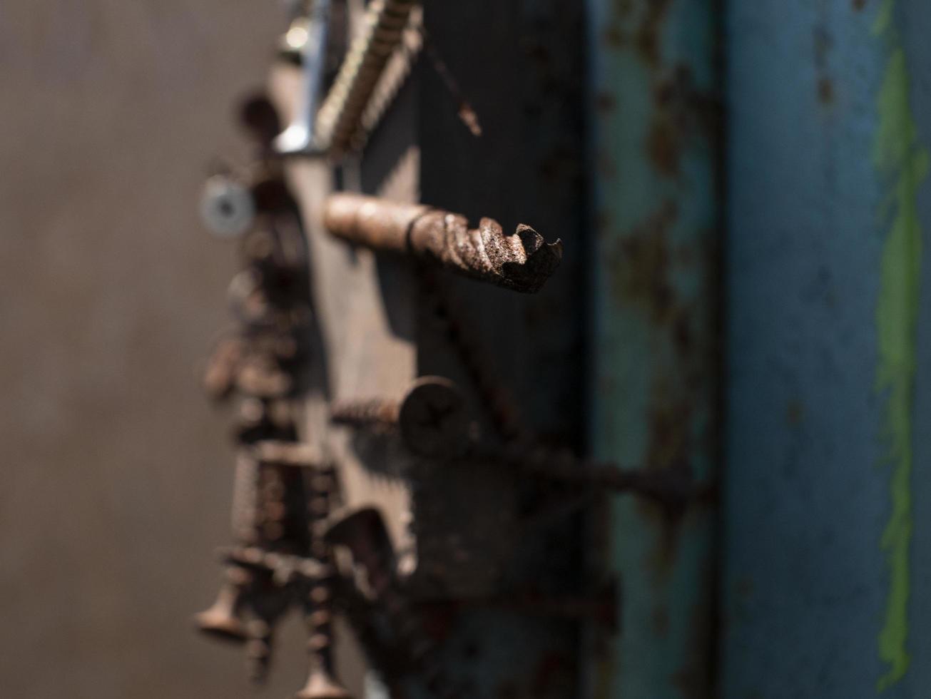 rusty screws on the magnet on the iron pole in the street photo