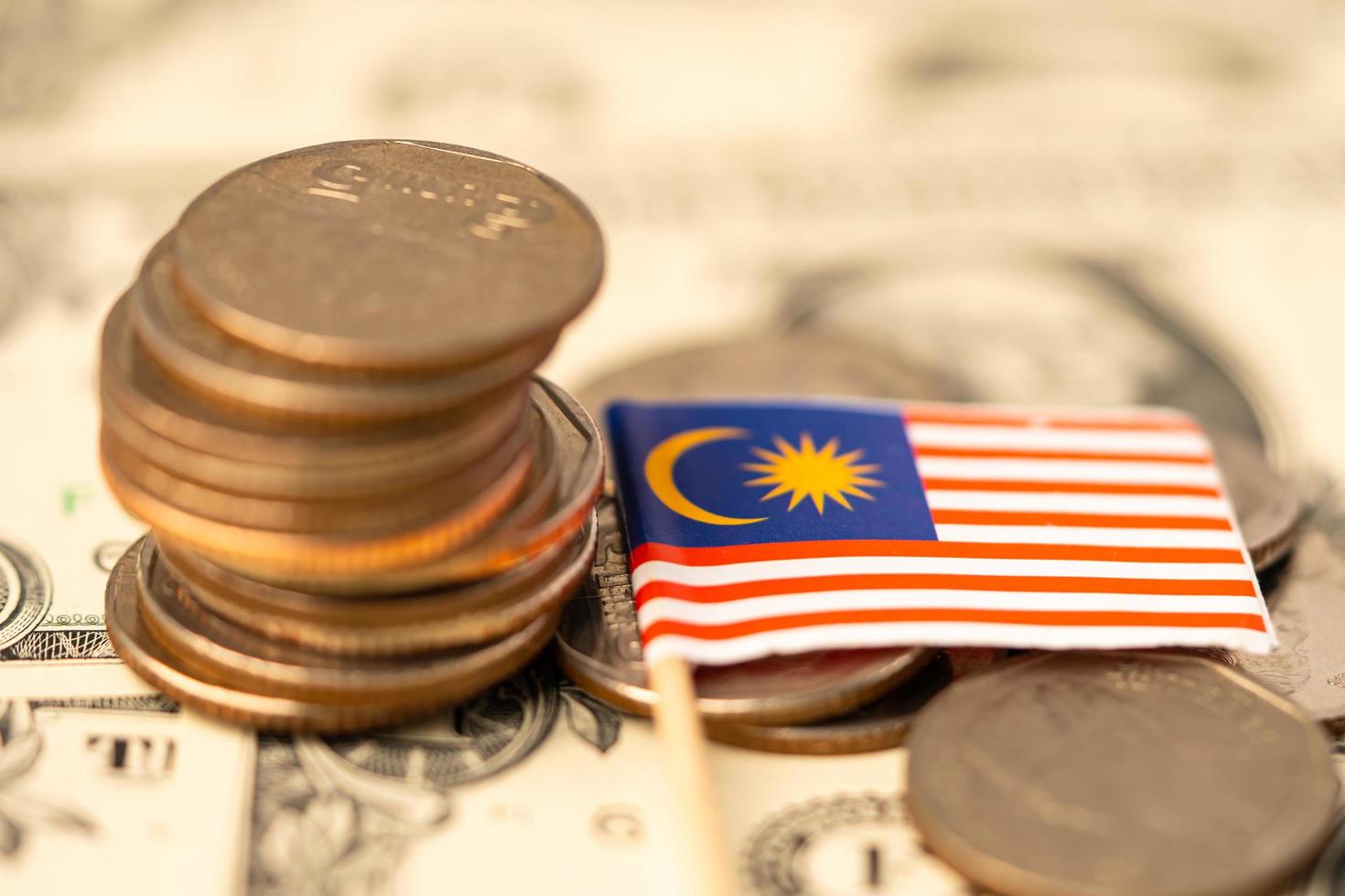 Malaysia Flag on coins background, Business and finance concept. photo