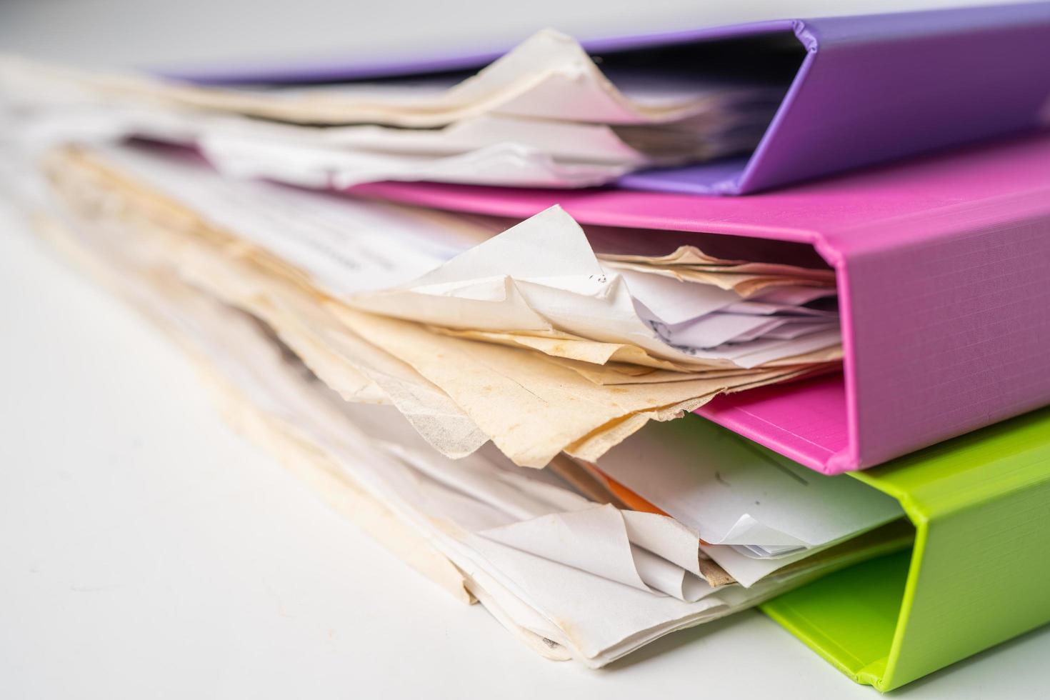 File Folder Binder stack of multi color on table in office. photo