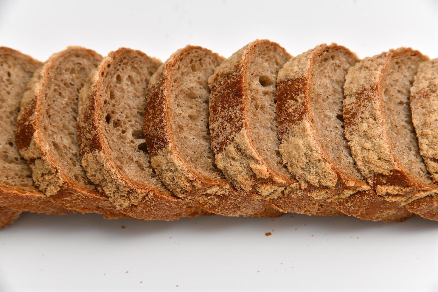 Slices of rye bread on white background photo