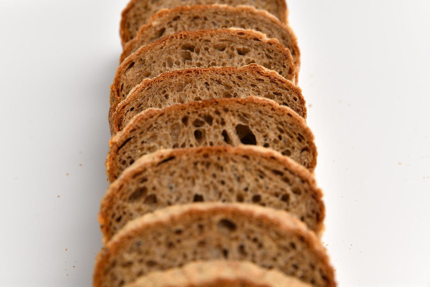 Slices of rye bread on white background photo