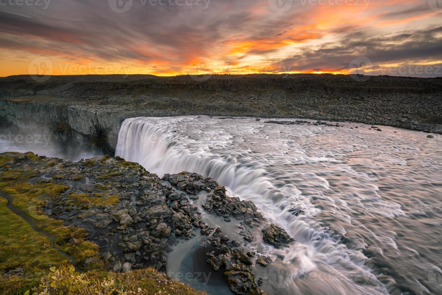 Detifoss waterfall with sunset in the background photo