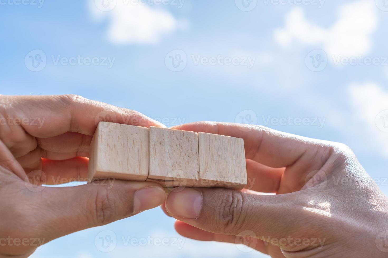 Blank wooden cube that you can put text or icon on in hand hold photo