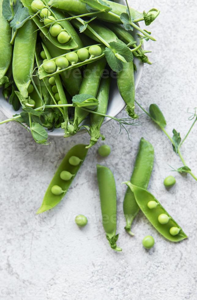 Fresh green peas pods and green peas photo