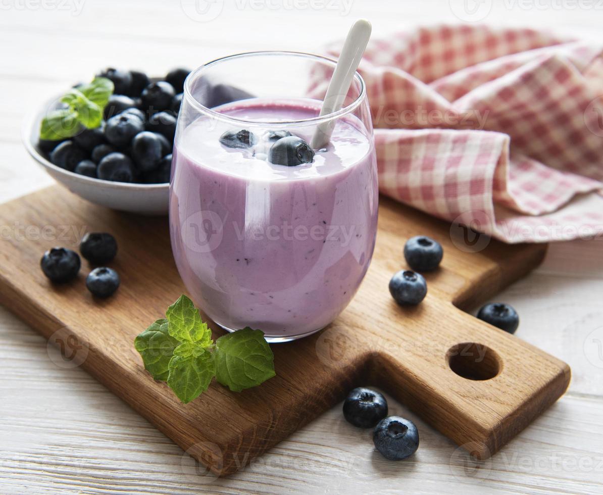 Glass of blueberry yogurt with blueberries photo