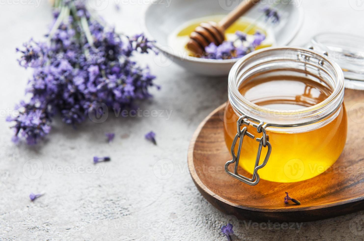 Jars with honey and fresh lavender flowers photo