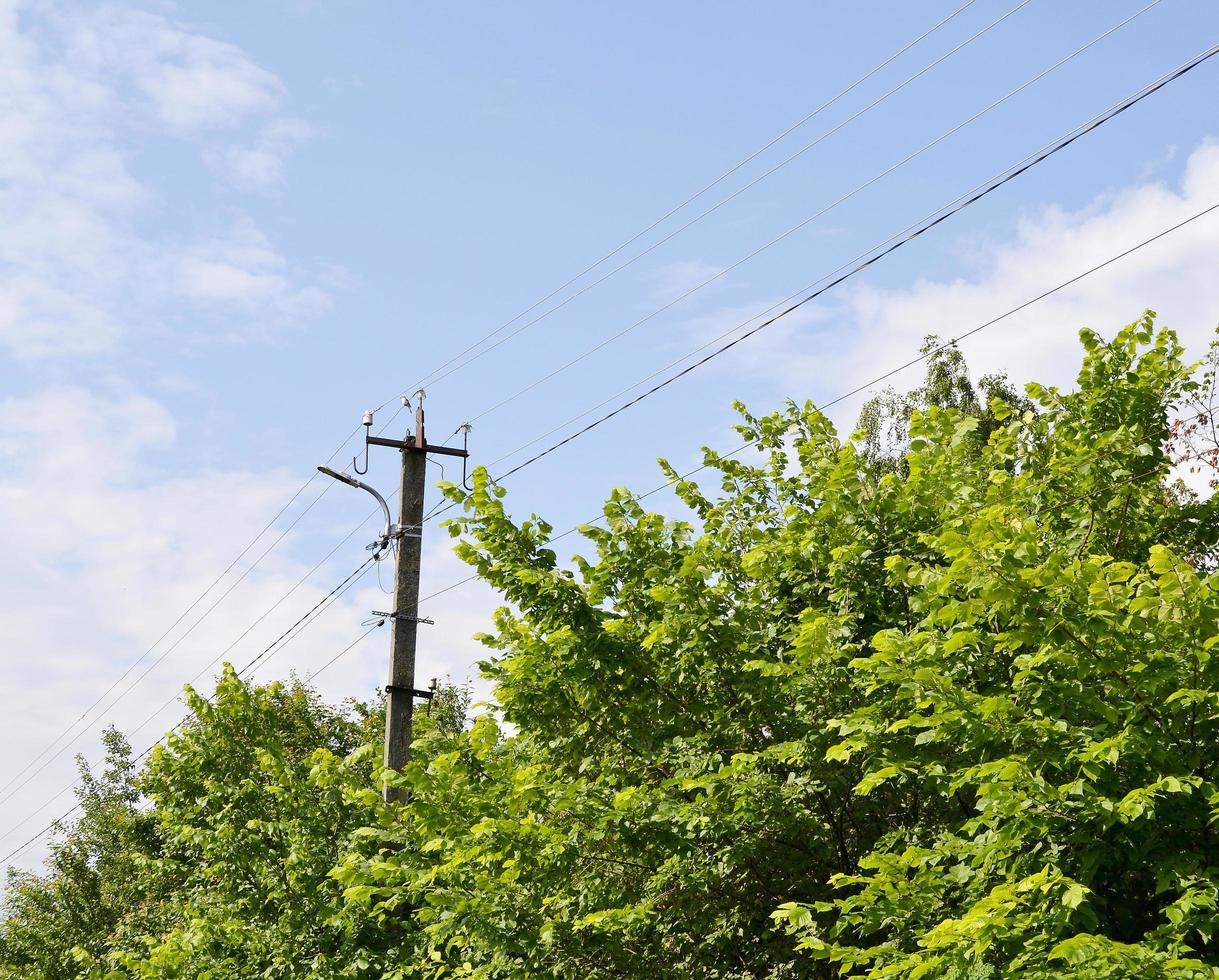 Power electric pole with line wire on colored background close up photo