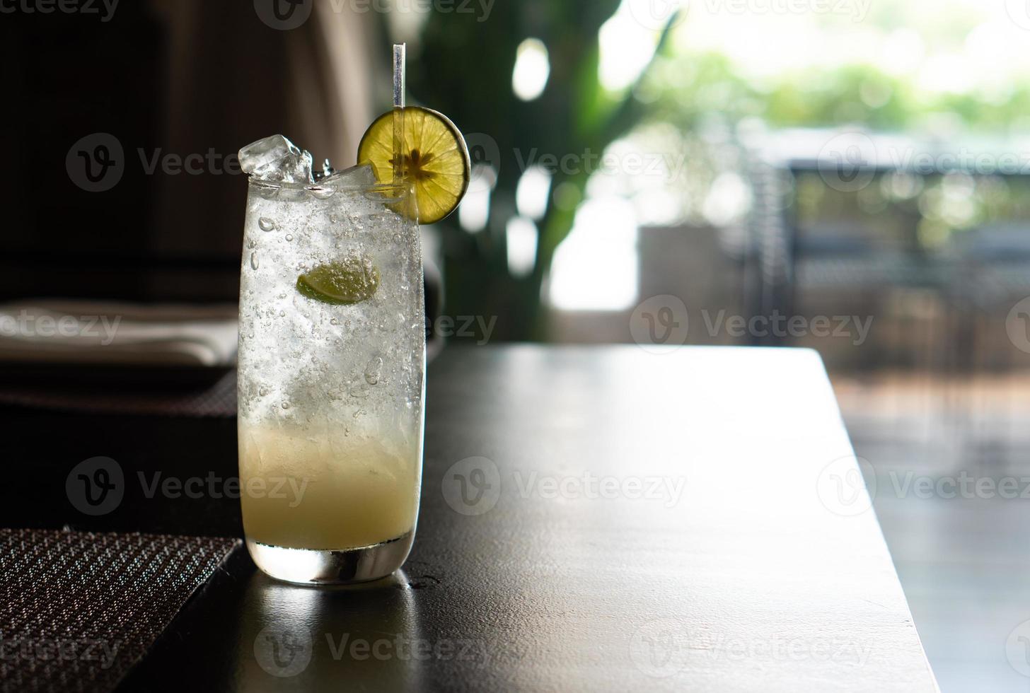 Iced lime soda in the glass on the table in the restaurant photo