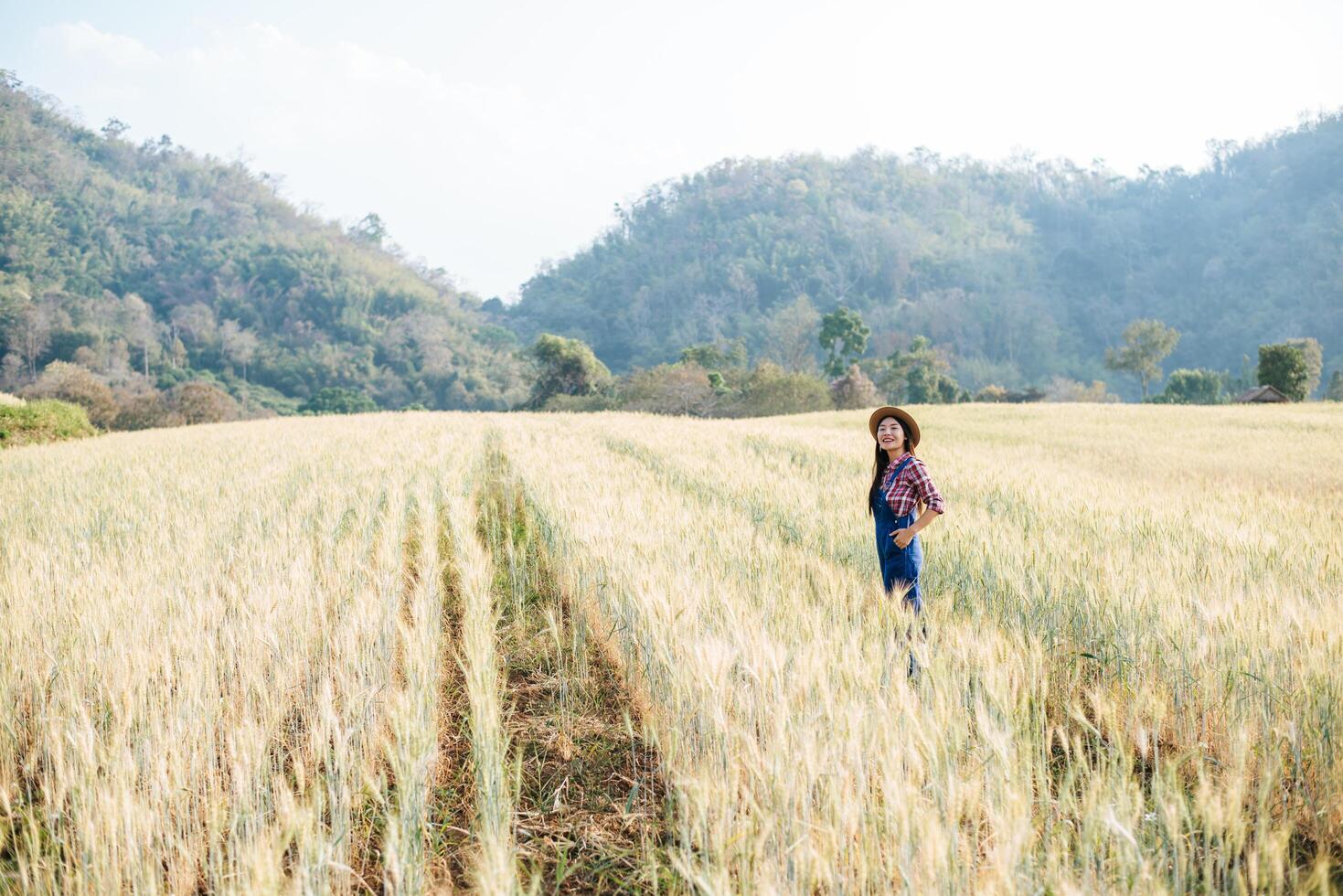 Woman farmer with barley field harvesting season photo