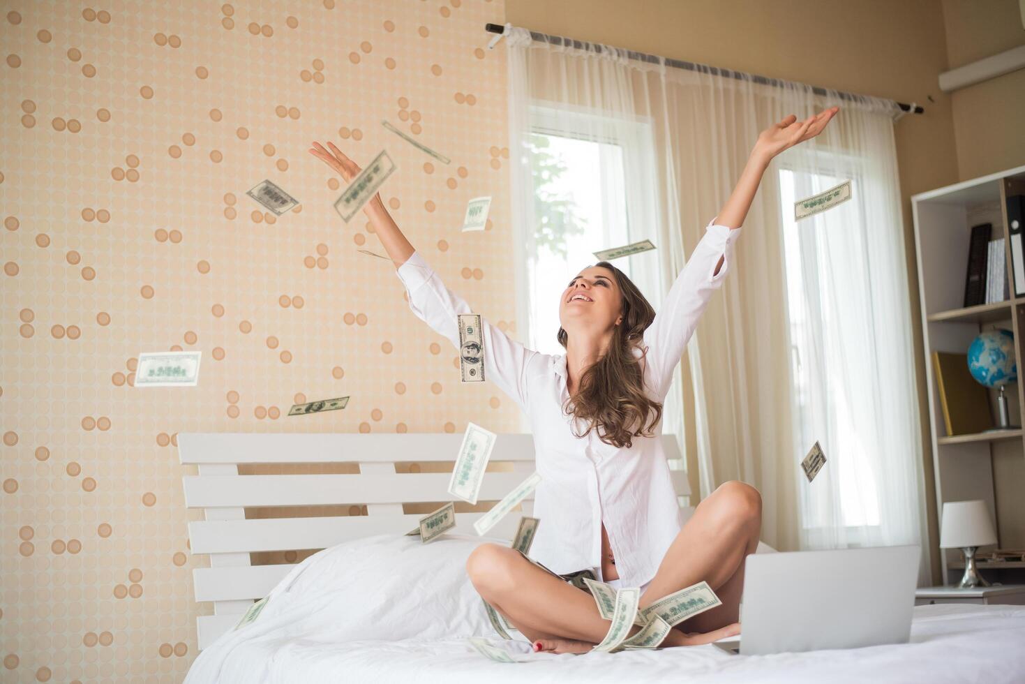 Woman with dollar bank note on the bed photo