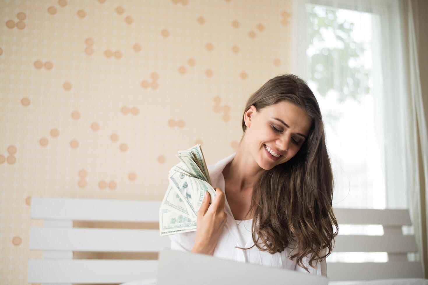 mujer, con, dólar, billete de banco, en la cama foto