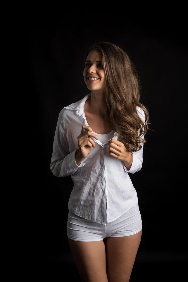 Beautiful woman with healthy body on black background photo