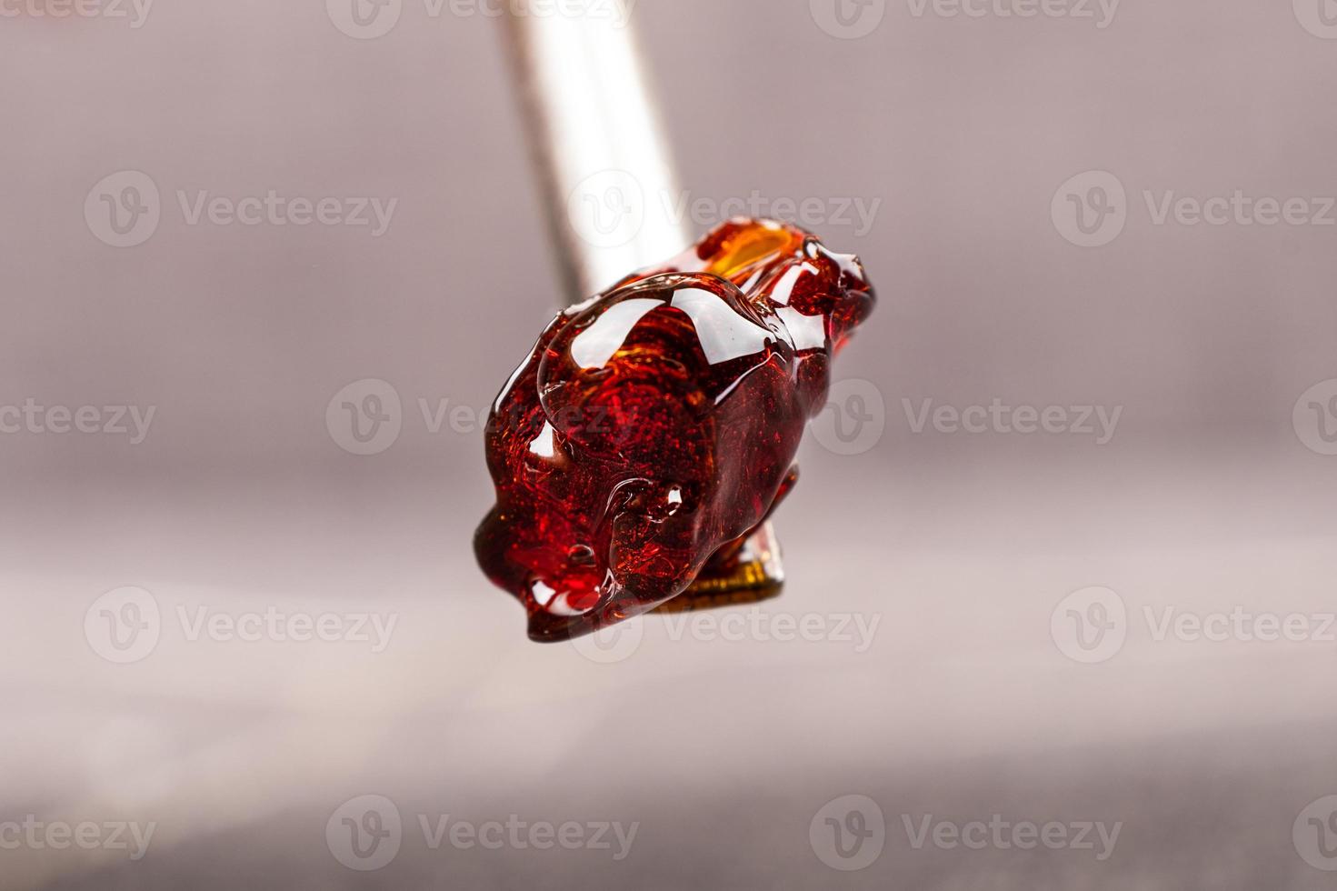 Dark cannabis resin wax on dab tool closeup photo