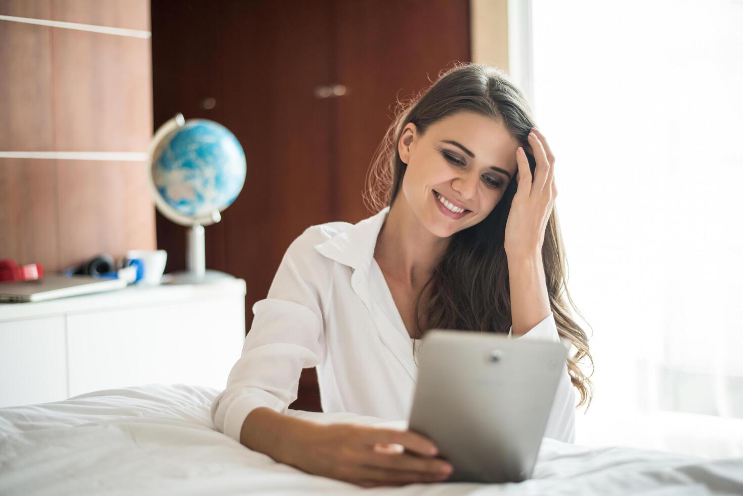 Portrait of woman lying at the bed photo