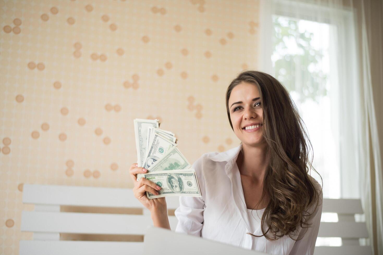 Woman with dollar bank note on the bed photo