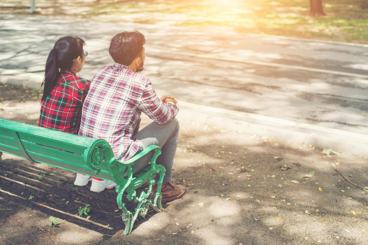 Young teenagers couple in love sitting together on the bench. photo