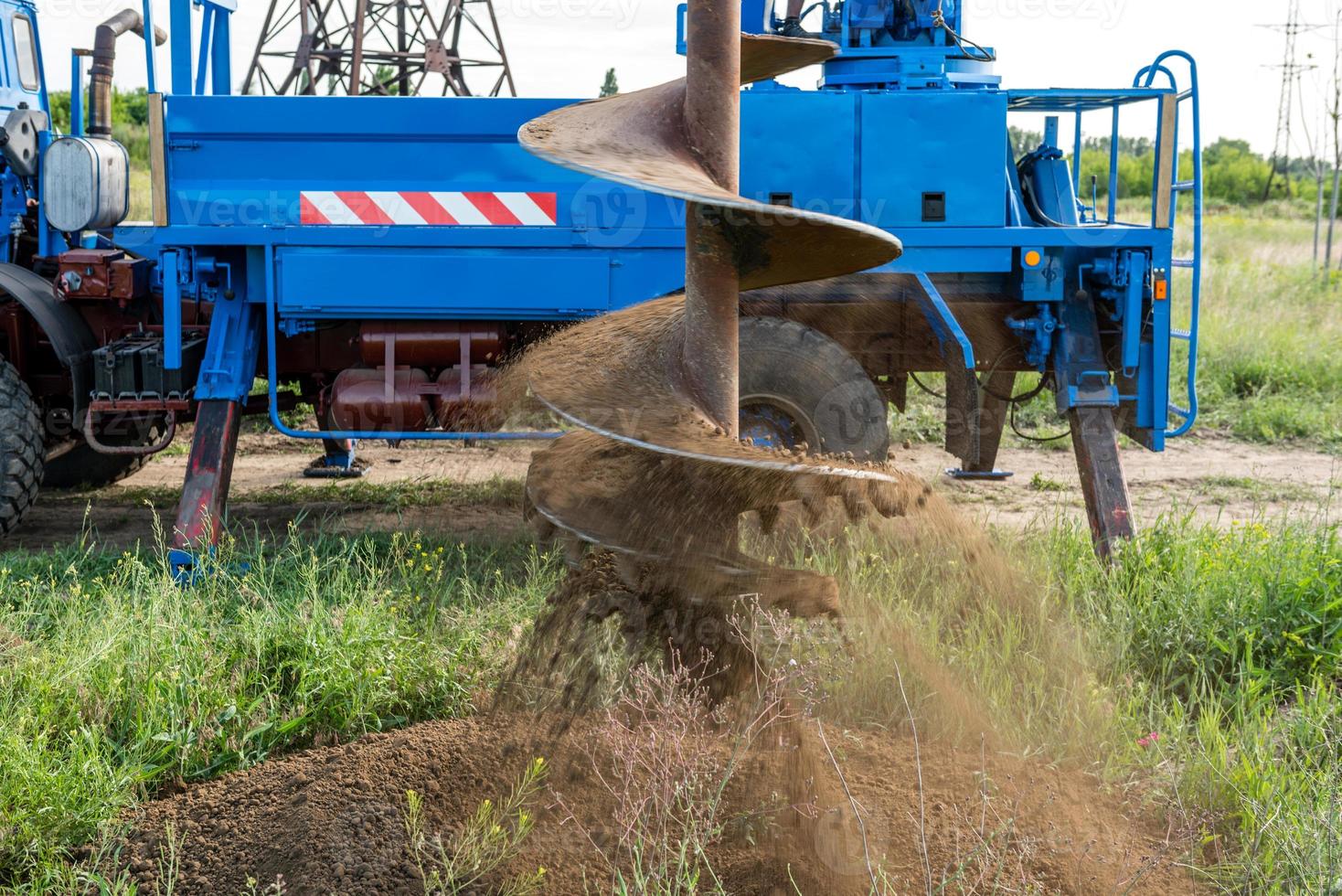 Tracer tractor with auger for soil drilling for piles photo