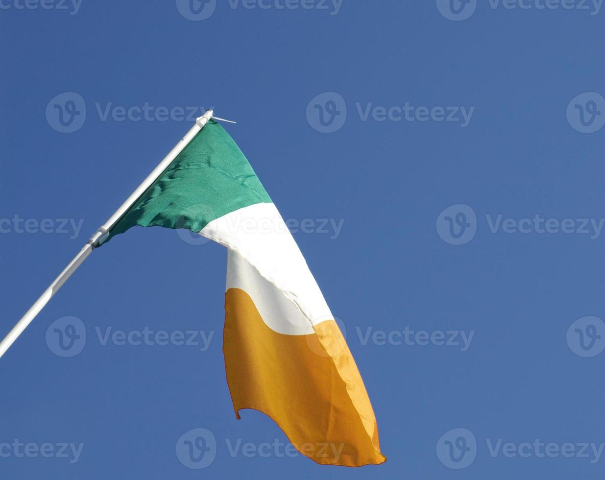 Irish flag over blue sky photo