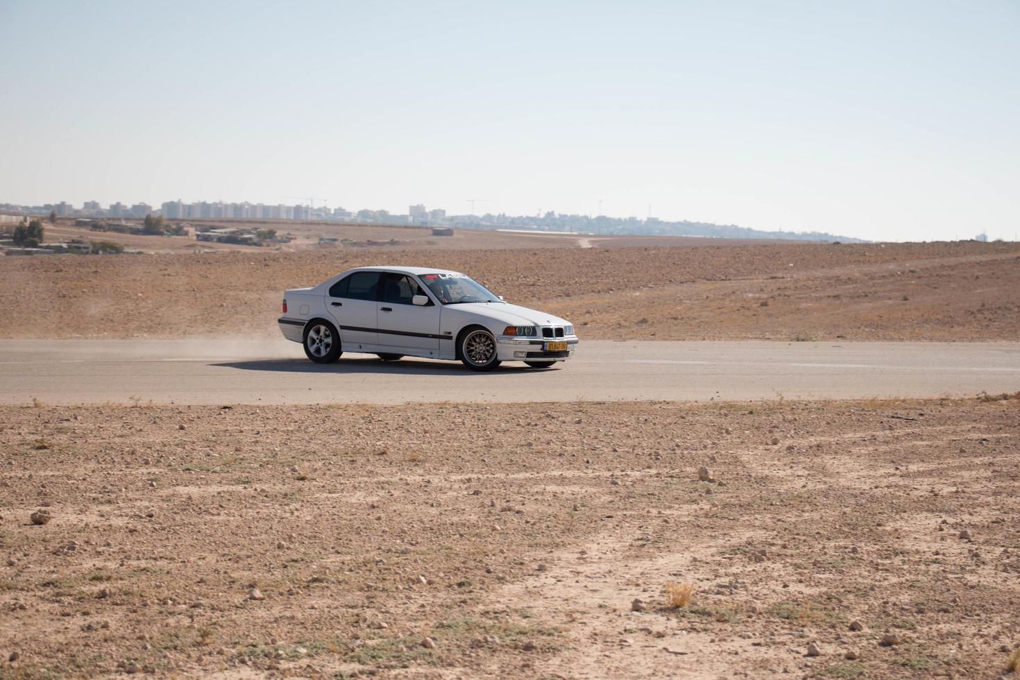 Cars on the race track and on the roads of the desert photo