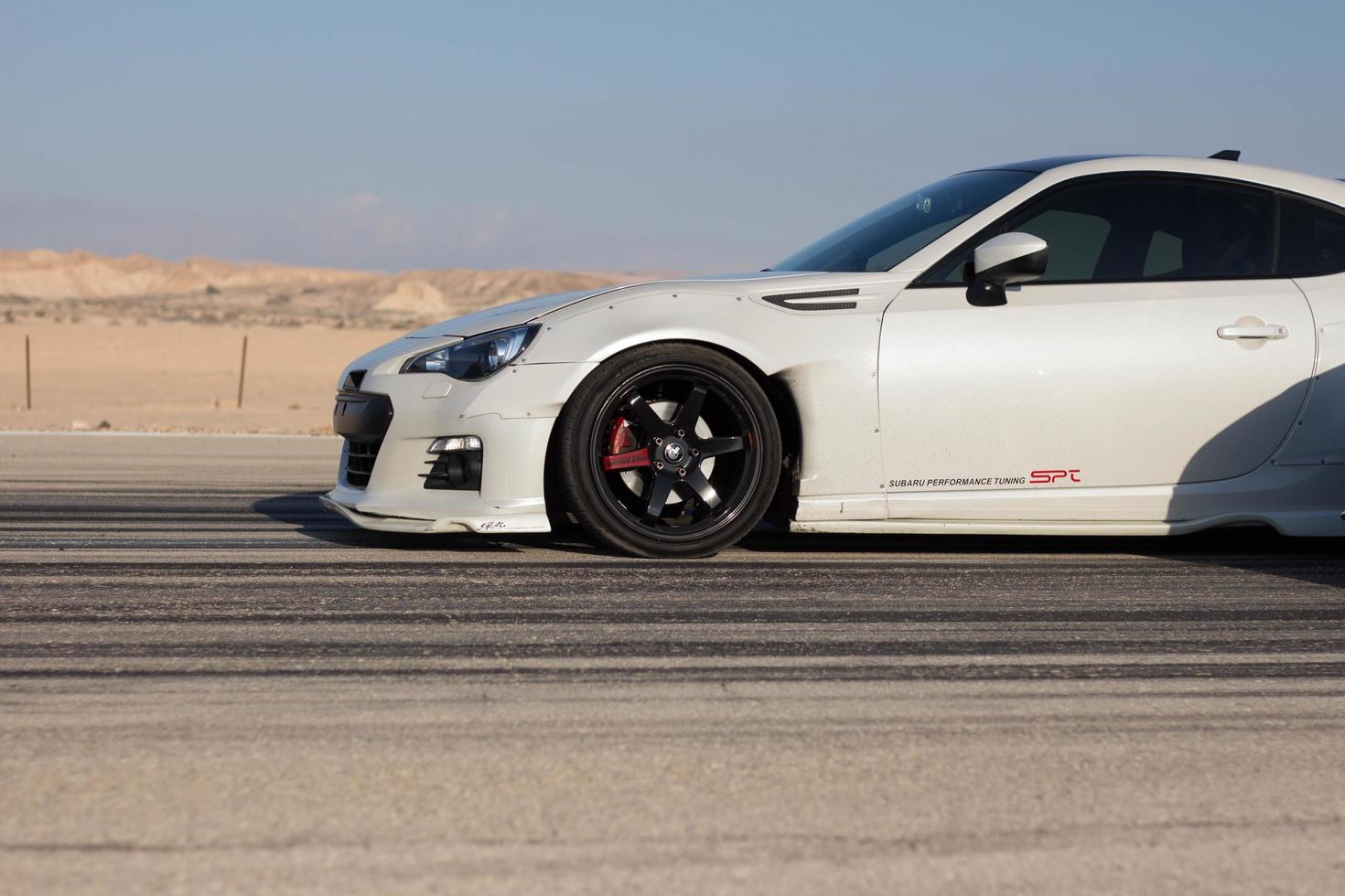 Cars on the race track and on the roads of the desert photo