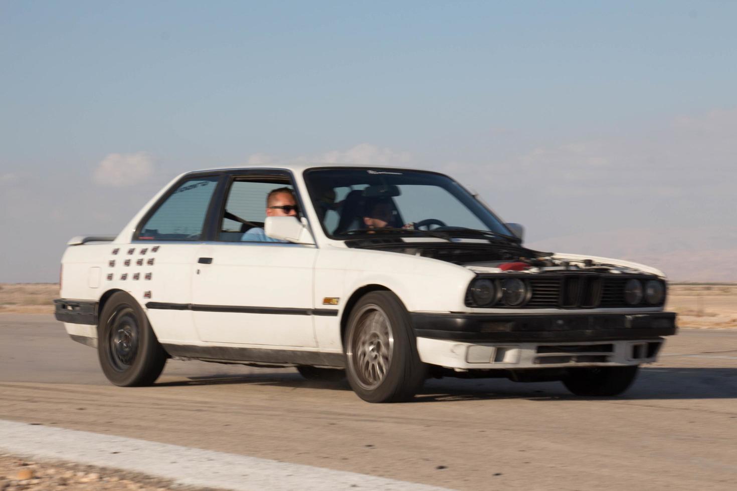 Cars on the race track and on the roads of the desert photo
